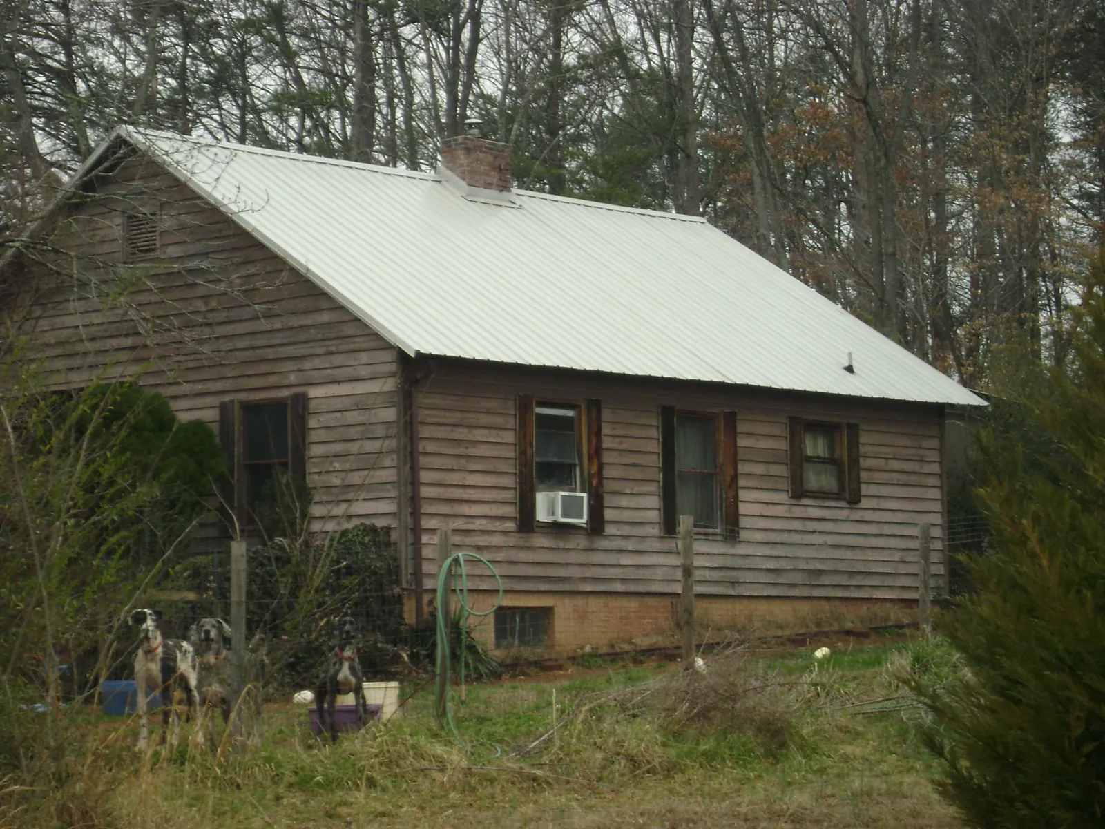 White metal roof on an old wood sided farmhouse, from a Metal Roof Installation job in Glendo
